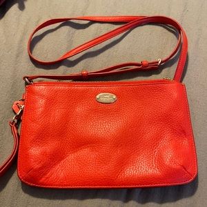 Coach crossbody bag, reddish-orangish color, adjustable strap.
